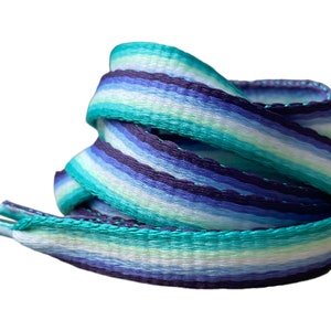 May include: Striped shoelaces in shades of blue, teal, and white. The shoelaces are woven with a textured pattern.
