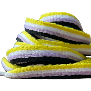 May include: Yellow, white, lavender, and black striped shoelaces. The shoelaces are folded and stacked on top of each other.