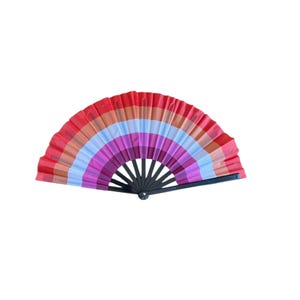 May include: A colorful hand fan with a rainbow design. The fan features a series of horizontal stripes in shades of red, orange, pink, purple, light blue, and white. The fan's frame is black.