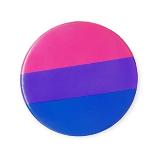 May include: A round button featuring the bisexual pride flag colours: pink, purple, and blue.