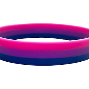 May include: A multi-colored silicone bracelet with pink, purple, and blue stripes. The bracelet is a symbol of bisexuality.