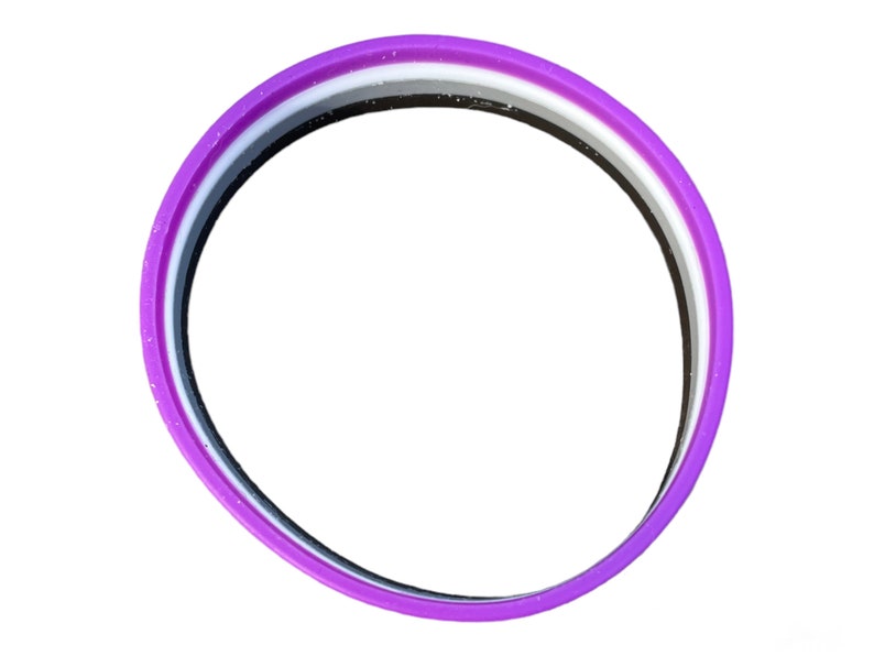 May include: A purple silicone bracelet with three stripes: black, white, and gray.