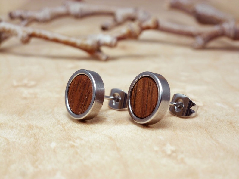 Modern men's wood and steel stud earrings, perfect for adding an earthy touch to any outfit.