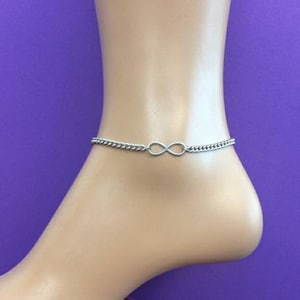 May include: Silver infinity symbol anklet with a chain link design.