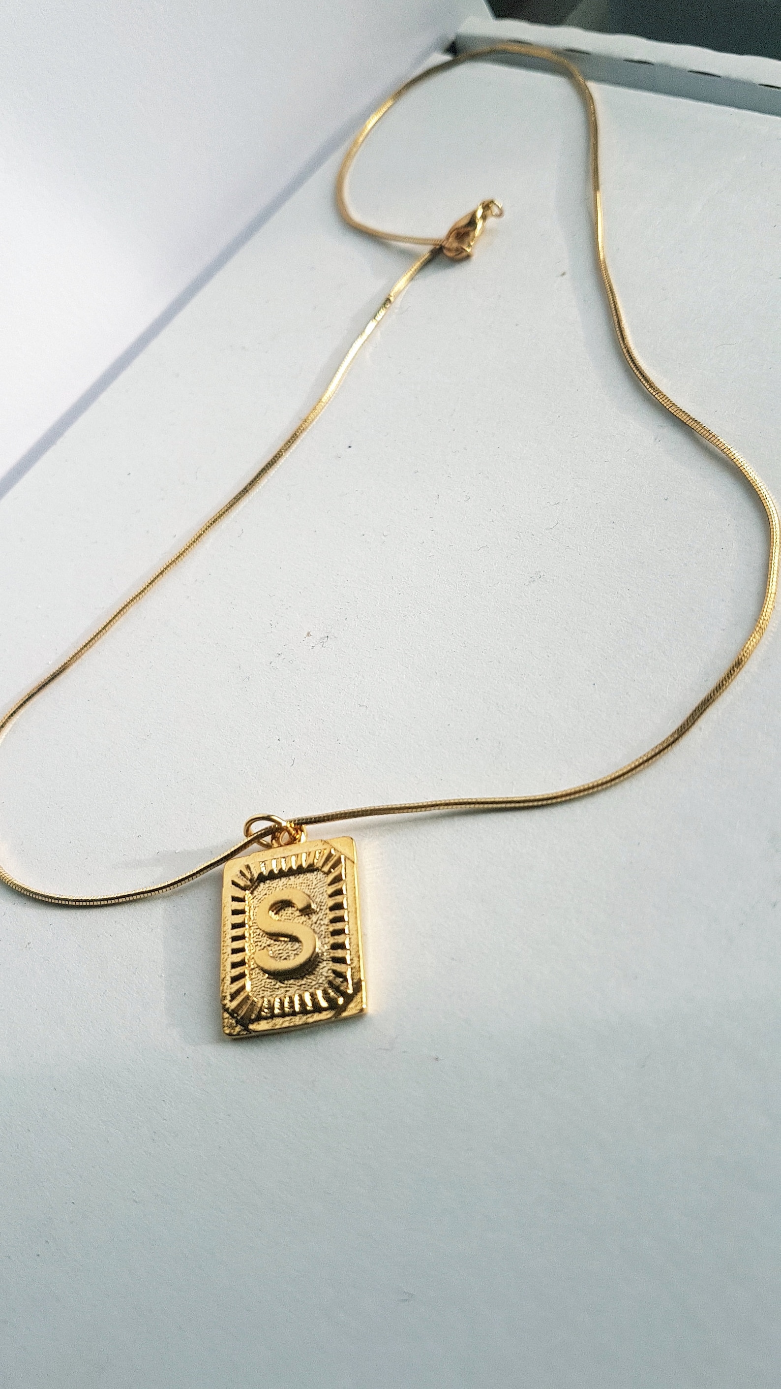 k name gold pendant