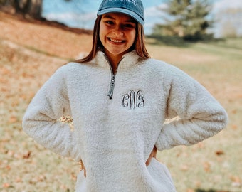 White pullover and black sherpa
