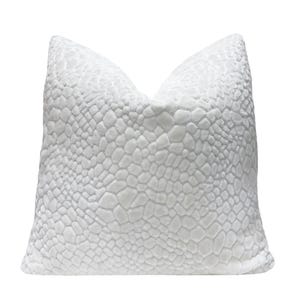May include: A white decorative pillow with a textured, reptile-skin-like pattern. The pillow is rectangular and has a soft, plush appearance. The pattern is a repeating design of rounded shapes.
