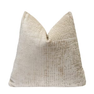 May include: A beige decorative pillow with a textured, grid-like pattern. The pillow has a soft, plush appearance and is designed for home decor. The neutral color and subtle texture make it suitable for various interior design styles.