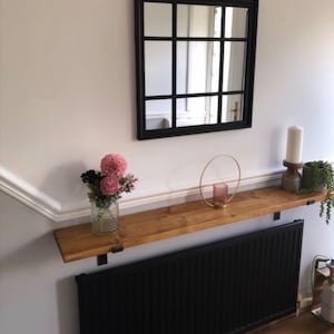 May include: A set of three ceramic mugs with a speckled, matte finish. The mugs are in shades of cream, light brown, and dark brown. Each mug has a simple, minimalist design and a rounded handle.