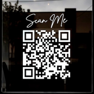 May include: A white ceramic mug with a black handle and the text "But First, Coffee" in a black, handwritten-style font. The mug is on a white surface.