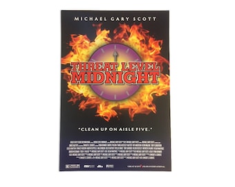May include: Movie poster for the film "Threat Level Midnight" starring Michael Gary Scott. The poster features a clock with a purple face and a red arrow pointing to midnight, set against a backdrop of flames. The tagline reads "Clean up on aisle five."