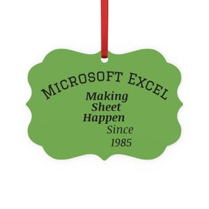 May include: A green, scalloped-edge ornament with the text "MICROSOFT EXCEL Making Sheet Happen Since 1985" in black. A red ribbon is attached at the top for hanging. The ornament is a fun, office-themed gift.