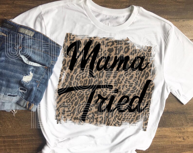 May include: White t-shirt with a leopard print design and the text "Mama Tried" in black.