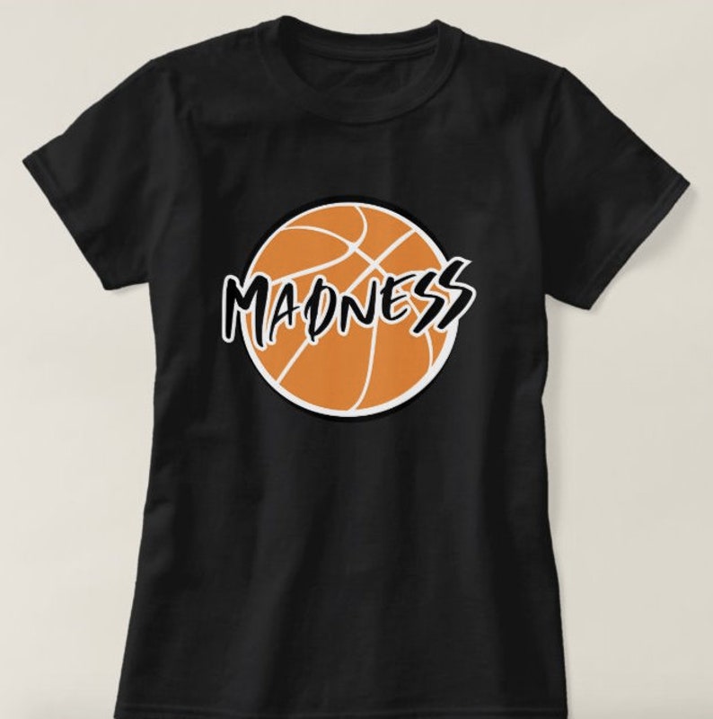 May include: Black t-shirt with an orange basketball graphic and the word "MADNESS" written in black across the basketball.