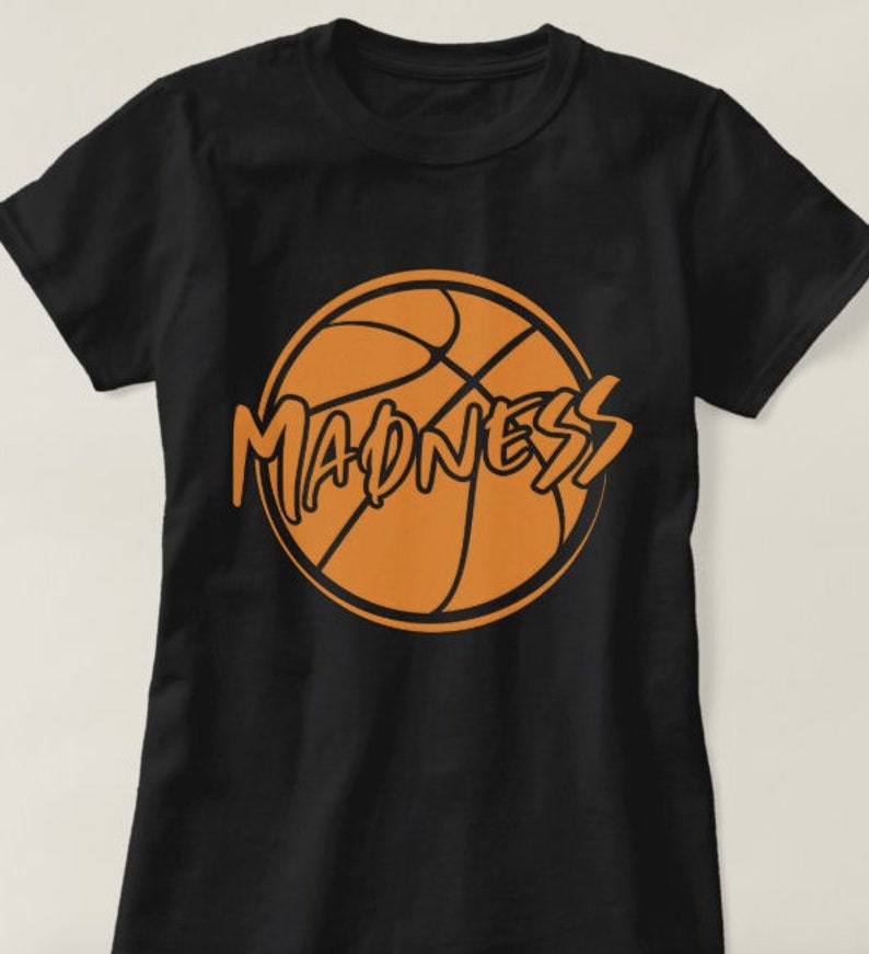 May include: Black t-shirt with an orange basketball graphic and the word "MADNESS" written in a stylized font.