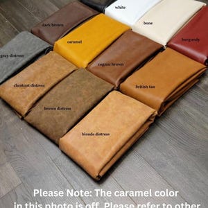 May include: A variety of leather swatches in different colors and textures, including black, white, bone, burgundy, gray distress, dark brown, caramel, cognac brown, british tan, chestnut distress, brown distress, and blonde distress.  Please Note: The caramel color in this photo is off. Please refer to other caramel photo listed for reference.
