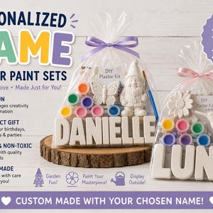 May include: Two clear plastic bags containing DIY plaster paint sets. Each set includes white plaster letters spelling DANIELLE or LUNA, a plaster garden figure of a gnome or hummingbird, a set of small paint pots, and a blue paintbrush.