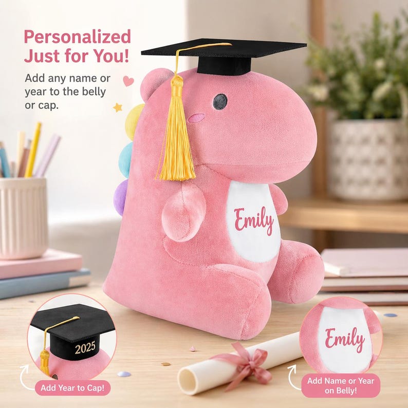 K&ouml;nnte beinhalten: Ein rosa Pl&uuml;schdinosaurier mit schwarzer Abschlusskappe und goldener Quaste. Der Dinosaurier hat einen wei&szlig;en Bauch mit dem Namen "Emily" aufgedruckt. Das Bild enth&auml;lt den Text "Personalisiert nur f&uuml;r dich!" und "F&uuml;ge einen beliebigen Namen oder ein Jahr auf dem Bauch oder der Kappe hinzu."
