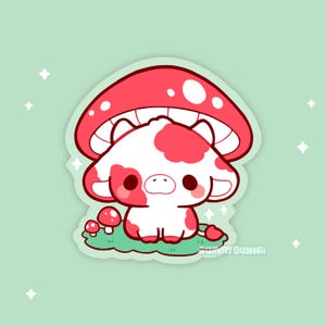 May include: A whimsical sticker featuring a cartoon cow with red spots and a red mushroom cap. The cow is sitting on green grass with small red mushrooms. The background is a light green color with white star accents. The sticker has a cute and playful design.
