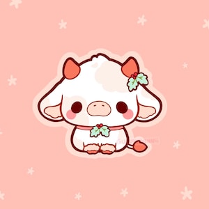 May include: A cute cartoon illustration of a white cow with pink accents. The cow has large, dark eyes, pink ears, and a pink nose. It is decorated with holly and berries. The background is a light pink with white star shapes.