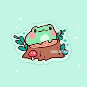 May include: A cute sticker featuring a cartoon frog with rosy cheeks sitting on a tree stump. The frog is light green, and the stump is brown with a red and white mushroom. Green leaves and sparkles surround the frog.