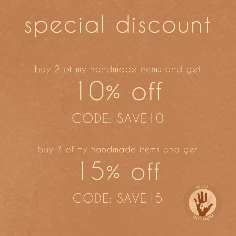 May include: A tan background with white text that reads "special discount". The text continues with "buy 2 of my handmade items and get 10% off CODE: SAVE 10" and "buy 3 of my handmade items and get 15% off CODE: SAVE 15". A small circle with a handprint and the text "EST. 2019 MADE ABROAD" is in the bottom right corner.