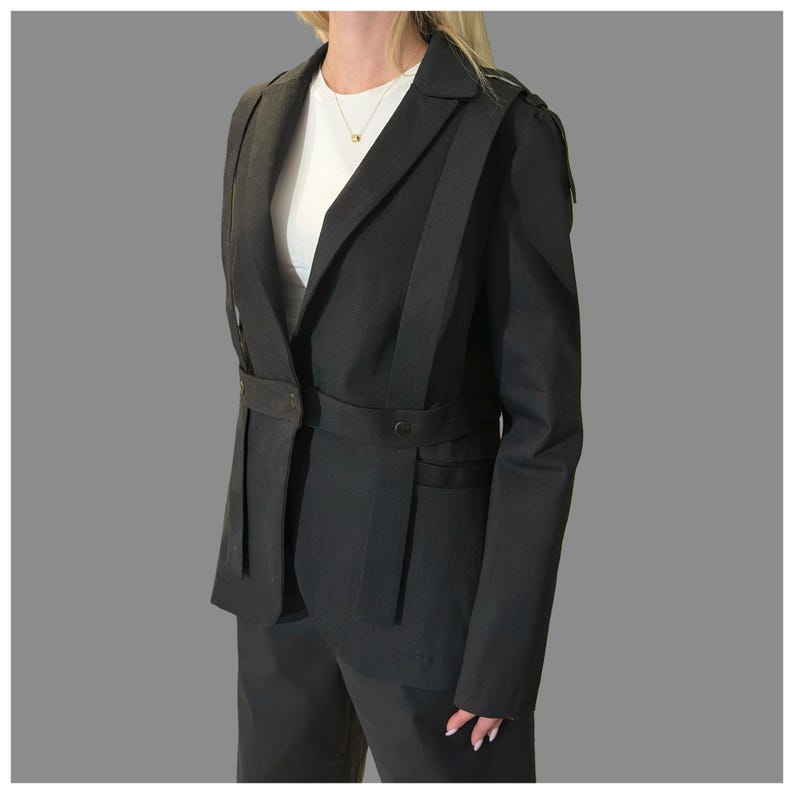 Side view of women’s black statement blazer with architectural lines and asymmetric detailing.