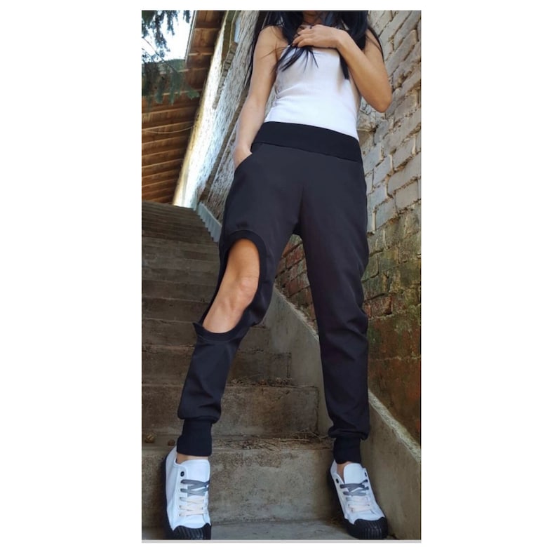 Women’s black asymmetrical pants with one leg cut-out detail, elastic waistband, side pockets and cotton rib accents