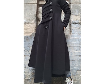May include: A long black coat with a high collar and multiple buttons down the front. The coat has a flared skirt and is made of a soft, comfortable fabric.