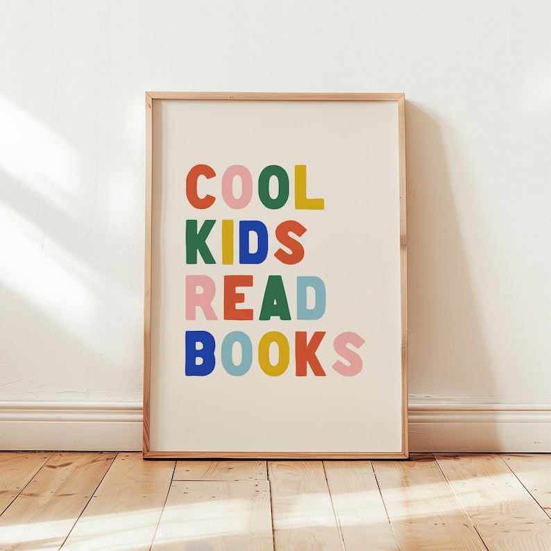 May include: A framed print with the text "COOL KIDS READ BOOKS" in colorful letters. The letters are in different colors, including red, orange, yellow, green, blue, and pink.