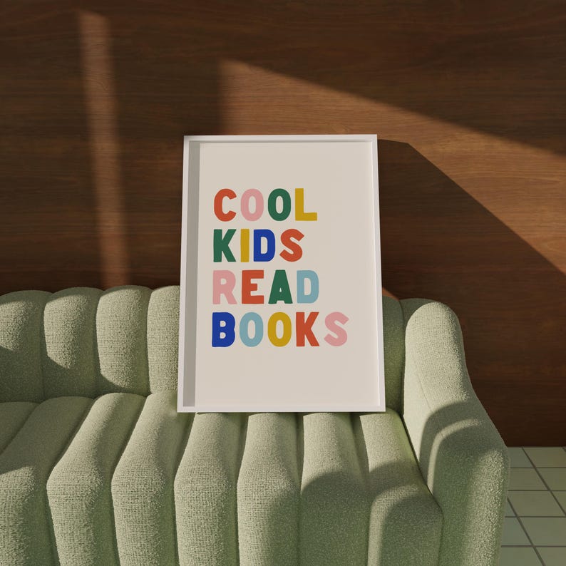 May include: A white framed print with the text "COOL KIDS READ BOOKS" in colorful letters. The letters are in different colors, including red, orange, yellow, green, blue, and pink.