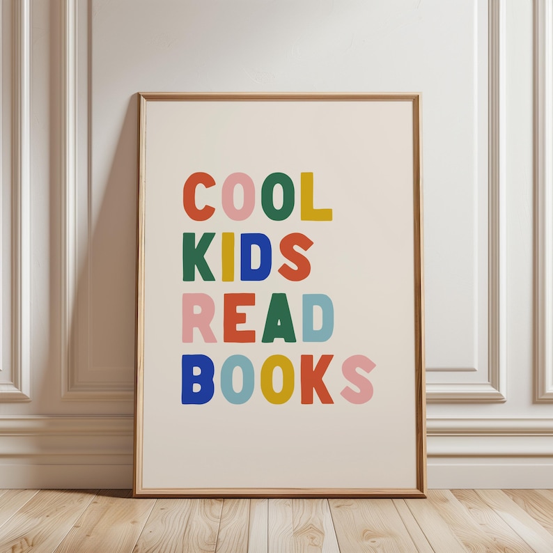 May include: A framed print with the text "COOL KIDS READ BOOKS" in colorful letters. The letters are in different colors, including red, blue, green, yellow, and pink.