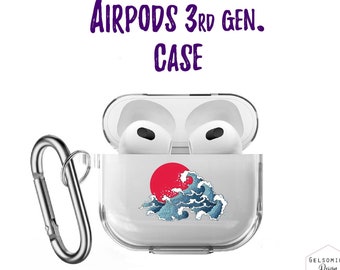 Peut inclure: Une coque transparente en plastique pour AirPods de 3ème génération avec un motif de soleil rouge et de vagues bleues. La coque est munie d'un mousqueton argenté.