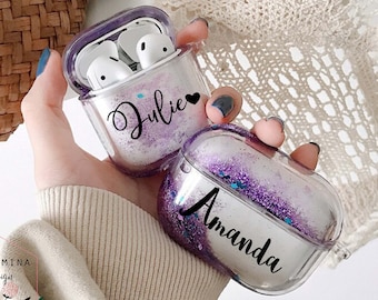 May include: Two clear plastic Airpod cases with glitter inside. One case has the name "Julie" with a heart and the other case has the name "Amanda".