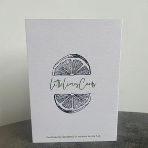May include: A white card with a black and white illustration of a lime wedge. The text "littlelimesCards" is written in green letters on the card. The text "Sustainably designed & created in the UK" is written in black letters at the bottom of the card.