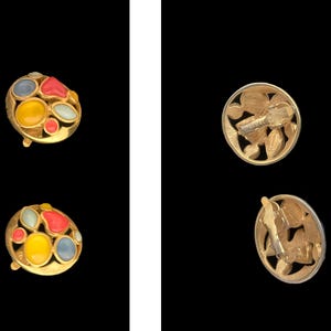 May include: A pair of gold-tone earrings with colorful enamel accents. The earrings feature a round design with a cluster of red, yellow, blue, and white enamel stones. The backs of the earrings are also gold-tone and feature a decorative design.