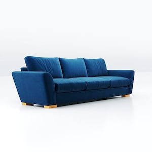 May include: A deep blue velvet sofa with three cushions and wooden legs.
