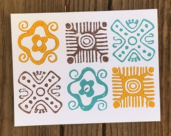 May include: Six square-shaped designs in yellow, brown, and teal colors. The designs are geometric and abstract, with circles, lines, and swirls.