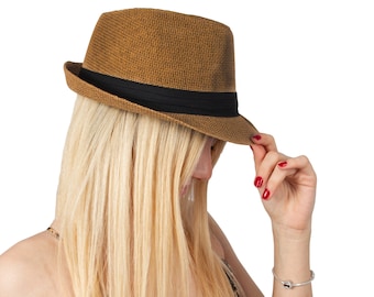 May include: A woman with long blonde hair wearing a brown fedora hat and a leopard print dress.