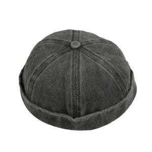May include: A dark grey cotton beanie with a rounded crown and a folded brim.