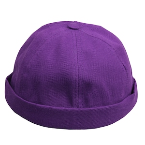 May include: A purple cotton beanie hat with a rolled brim.