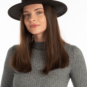 May include: A black fedora hat with a wide brim. The hat is made of a soft, felt-like material.