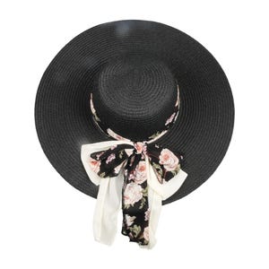 May include: A black wide-brimmed sun hat with a floral ribbon tied around the crown.