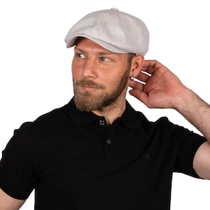 May include: A light gray linen newsboy cap with a slightly textured surface.