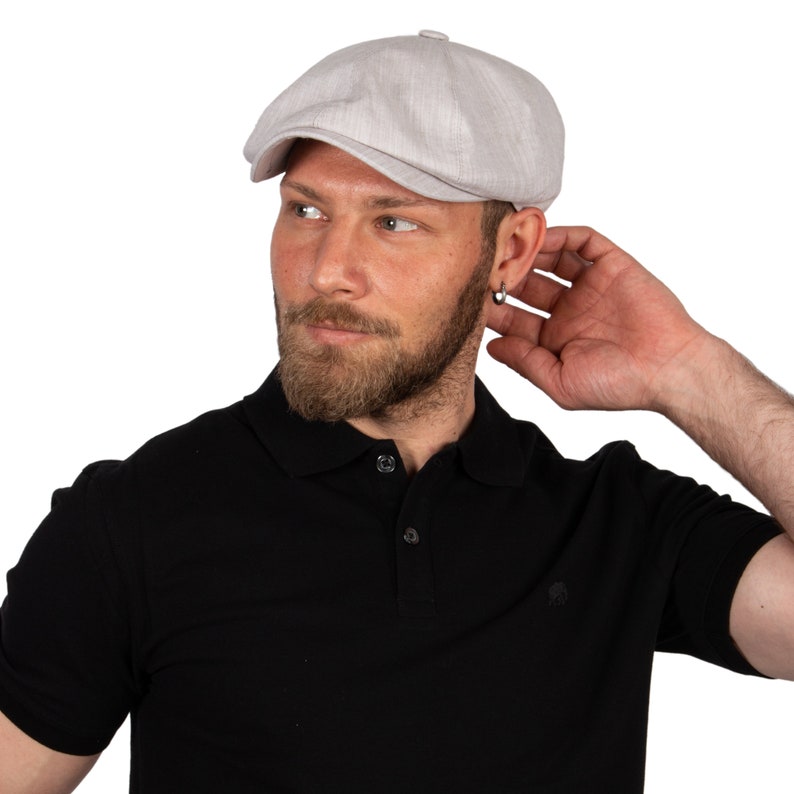 May include: A light gray linen newsboy cap with a slightly textured surface.