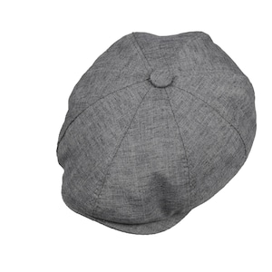 May include: A grey newsboy cap, featuring a rounded crown and a small, stiff peak. The cap is made from a textured fabric and has a button detail at the top. A classic style suitable for various outfits.