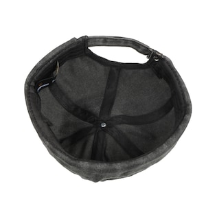 May include: Dark gray cap with a curved brim and adjustable strap. The interior features a black lining and a central button. The cap is made of a textured fabric, suitable for casual wear.