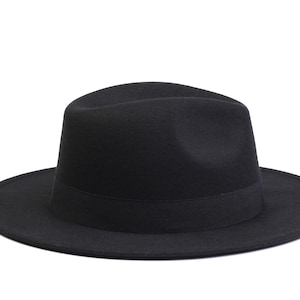 May include: A black fedora hat with a wide brim and a black ribbon band.
