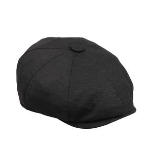 May include: A black newsboy cap with a rounded crown and a small, stiff brim. The cap has a textured appearance and a button detail at the top. The hat is set against a white background.