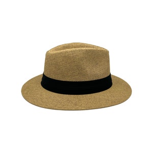 May include: A tan fedora hat with a black band around the crown.